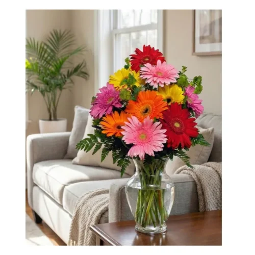 Arreglo floral con gerberas frescas en colores surtidos y follaje verde, entrega Guatemala.